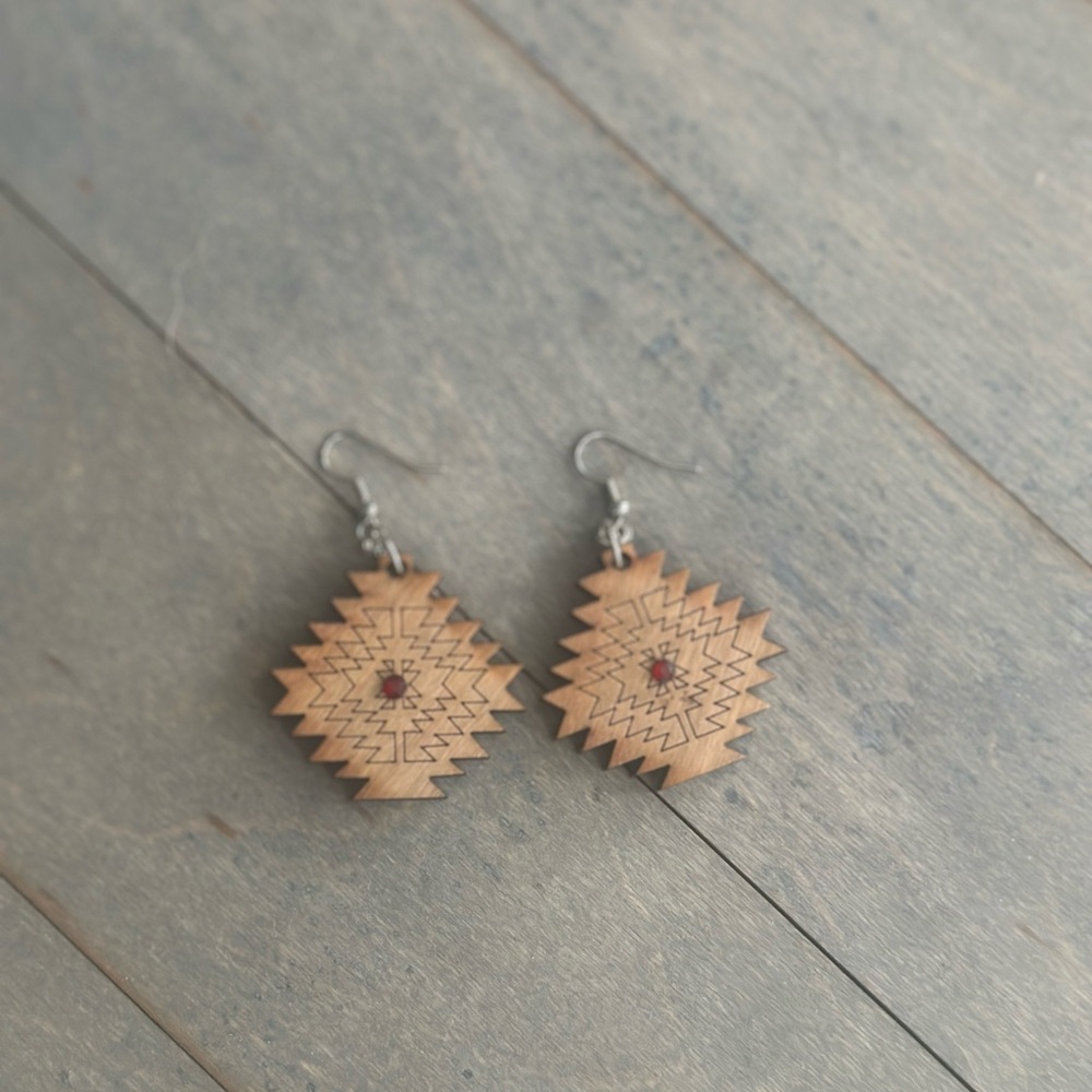 aztec cutout design shaped earrings with red jewel